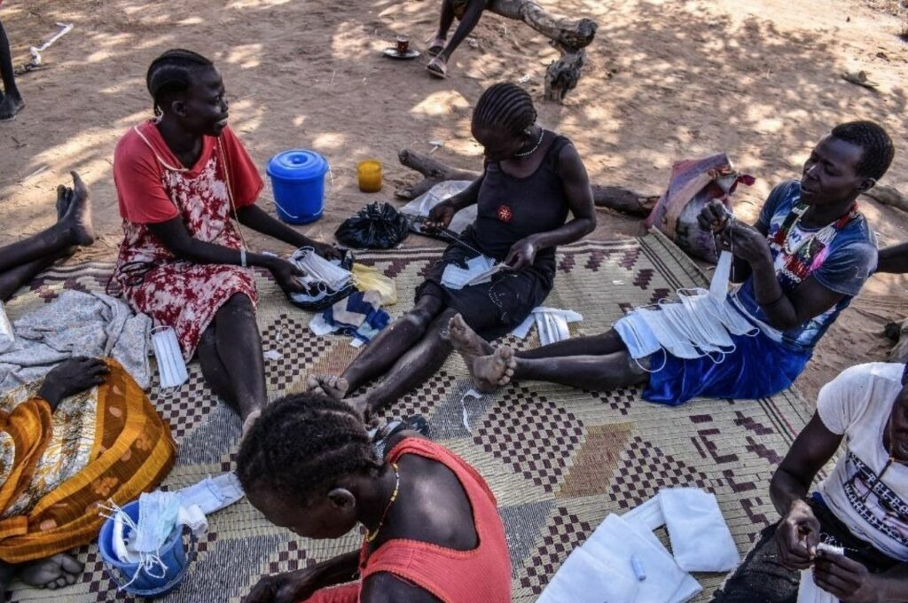 Face masks and medical supplies being distributed during a humanitarian aid activity for refugees.